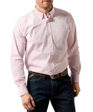 A man wearing a light pink long-sleeve button-down shirt tucked into dark blue jeans with a brown belt, shown from the chin down against a plain white background.
