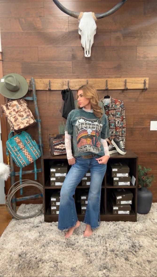 Woman in a rustic interior setting with cowboy-themed decor