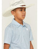 Young boy wearing a white cowboy hat and a blue patterned shirt against a plain background