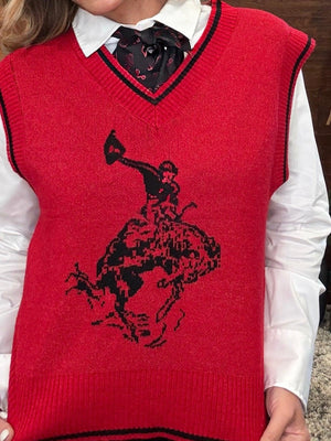 A red knit sweater vest with black trim and a black cowboy riding a bucking horse graphic, worn over a white collared shirt and black bow tie.