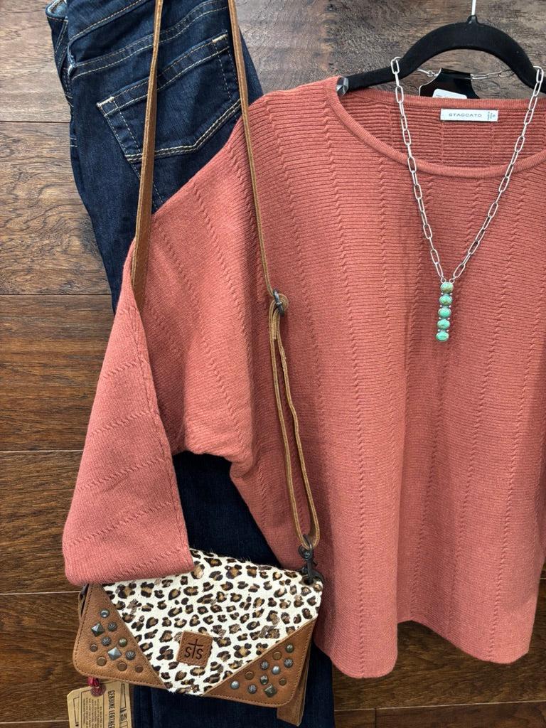 This sweater features a refined vertical texture, long dolman sleeves, and a classic boat neckline