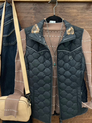 A black quilted zip-front vest with decorative tan and black geometric embroidery on the collar