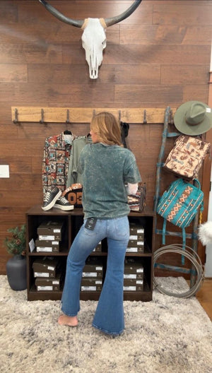 Person wearing a graphic t-shirt with text and design