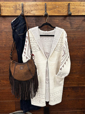 A cream-colored textured knit cardigan sweater with geometric patterns.