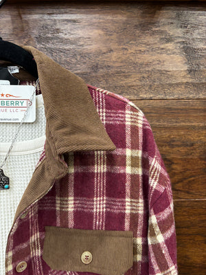 A burgundy and beige plaid flannel shirt with a brown corduroy collar and chest pockets