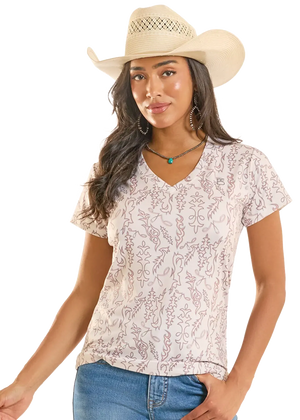 Woman wearing a floral blouse and cowboy hat on a white background