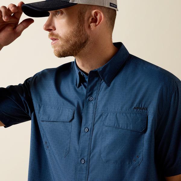 Man wearing a blue shirt and cap on a beige background