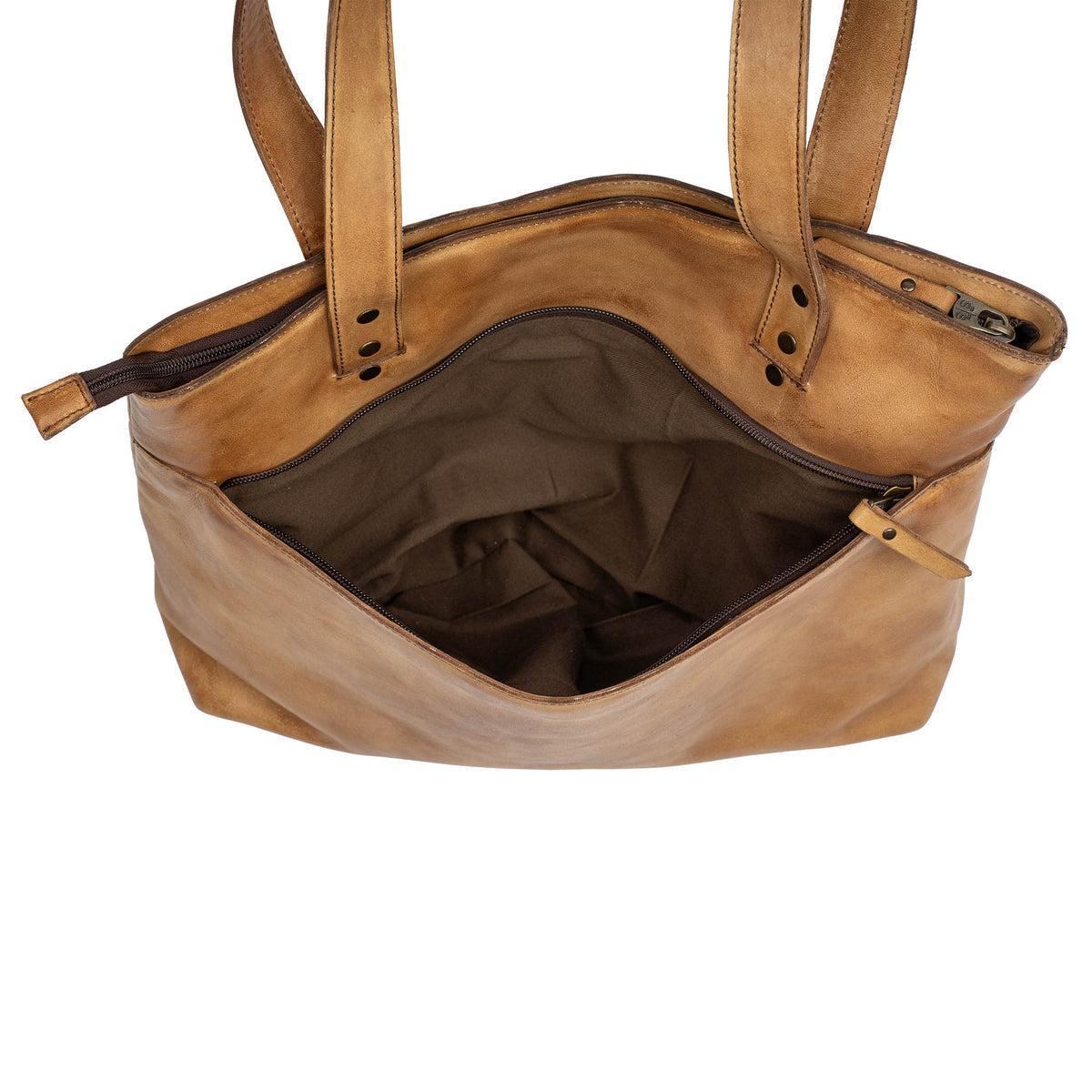 Brown leather handbag with open top on a white background