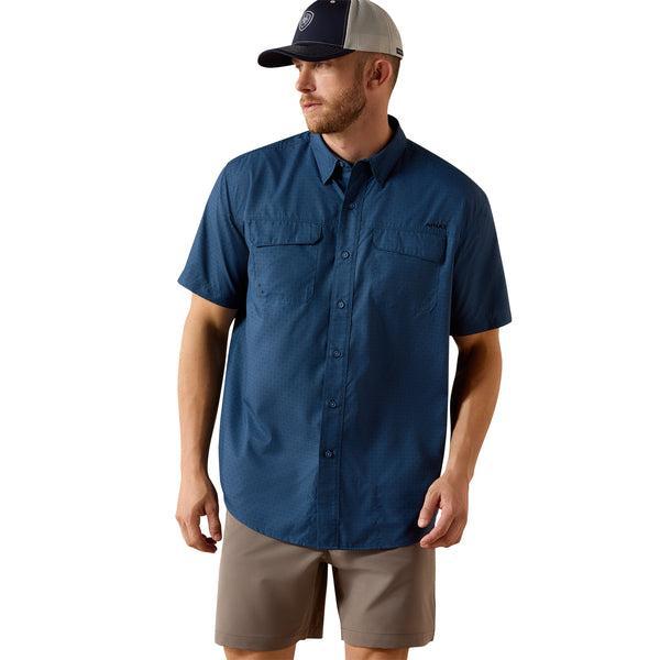 Man wearing a blue short-sleeve shirt, beige shorts, and a cap on a white background