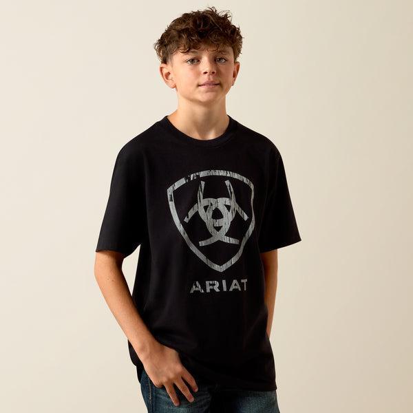 Child wearing a black Ariat t-shirt with a logo on a beige background