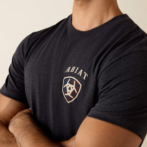 Man wearing a black t-shirt with 'Ariat Boots' logo on the back