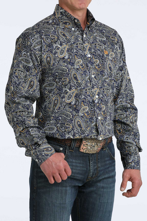 Man wearing a patterned shirt and jeans on a white background