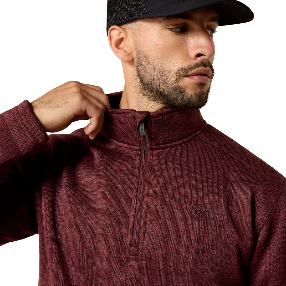 Man wearing a maroon half-zip sweatshirt with a logo on a white background
