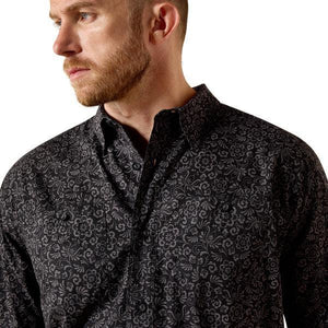 Man wearing a black patterned short-sleeve shirt