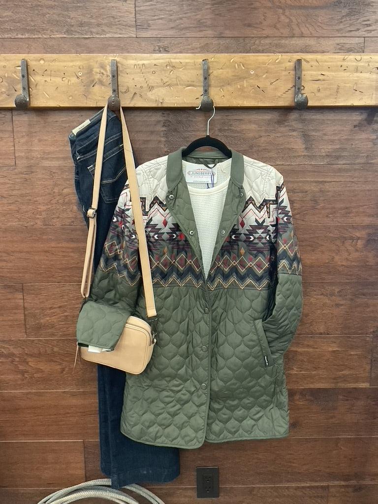 An olive green quilted jacket with a colorful geometric pattern across the chest and upper sleeves