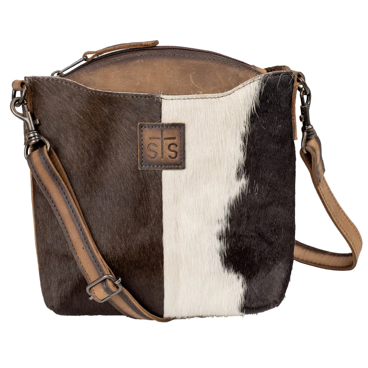 Brown and white cowhide leather bag with brown leather accents on a white background