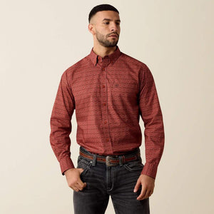 A man wearing a long-sleeve button-down shirt with a red and black geometric pattern