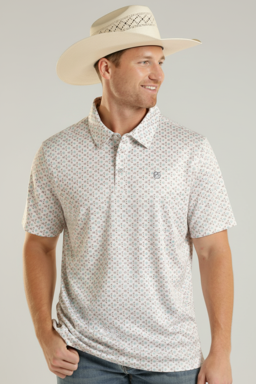 Man wearing a patterned polo shirt and straw hat outdoors