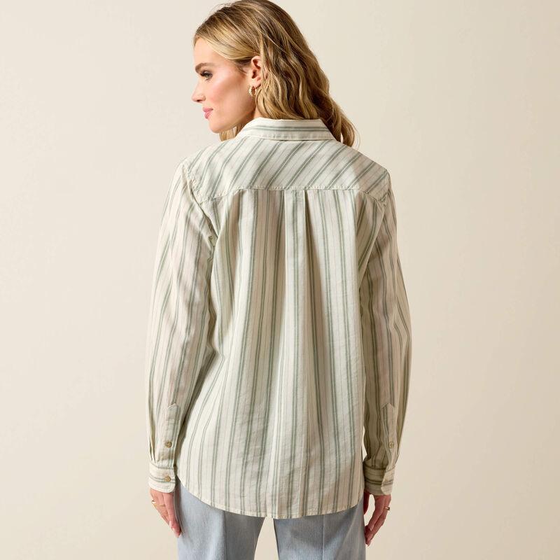 Woman wearing a striped shirt against a beige background