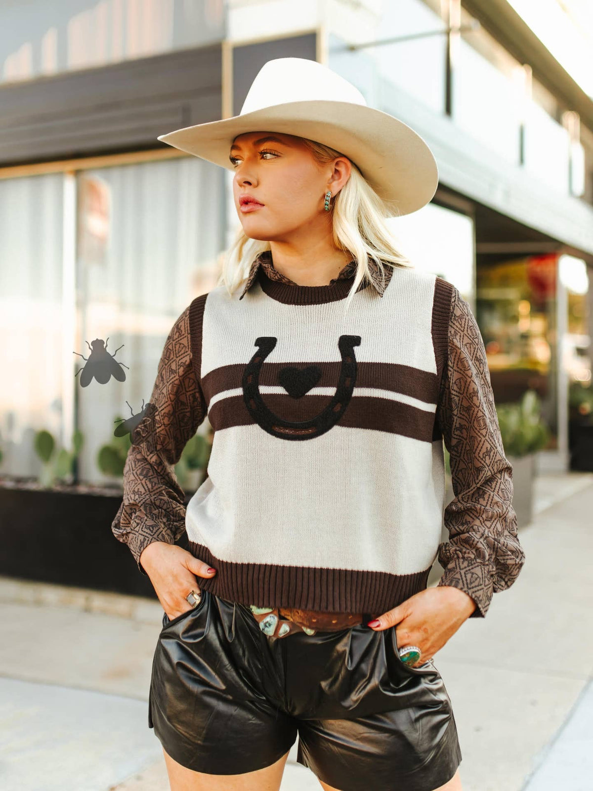 Women’s sweater vest with heart and horseshoe on front.