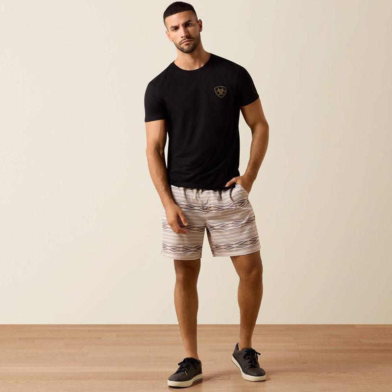 Man wearing a black t-shirt with 'Ariat Int.' logo on the back