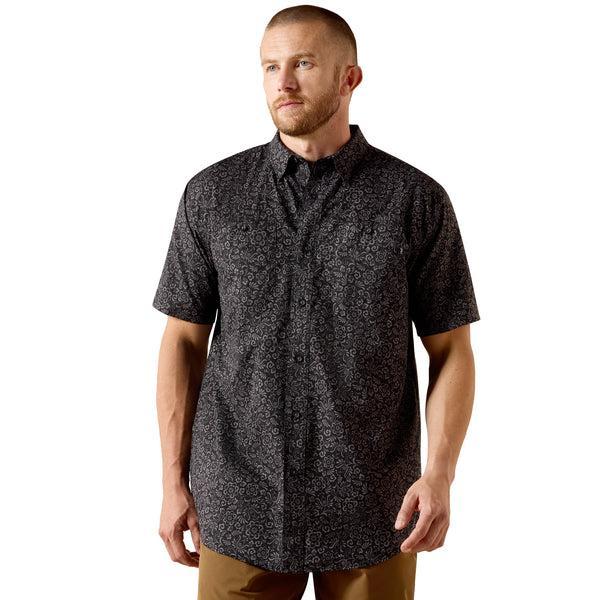 Man wearing a black patterned short-sleeve shirt
