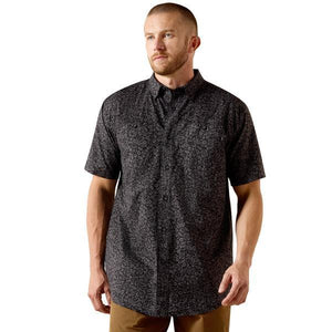 Man wearing a black patterned short-sleeve shirt