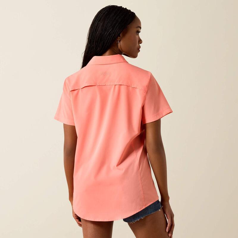 Woman wearing a pink shirt against a beige background