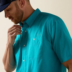 Man wearing a turquoise shirt