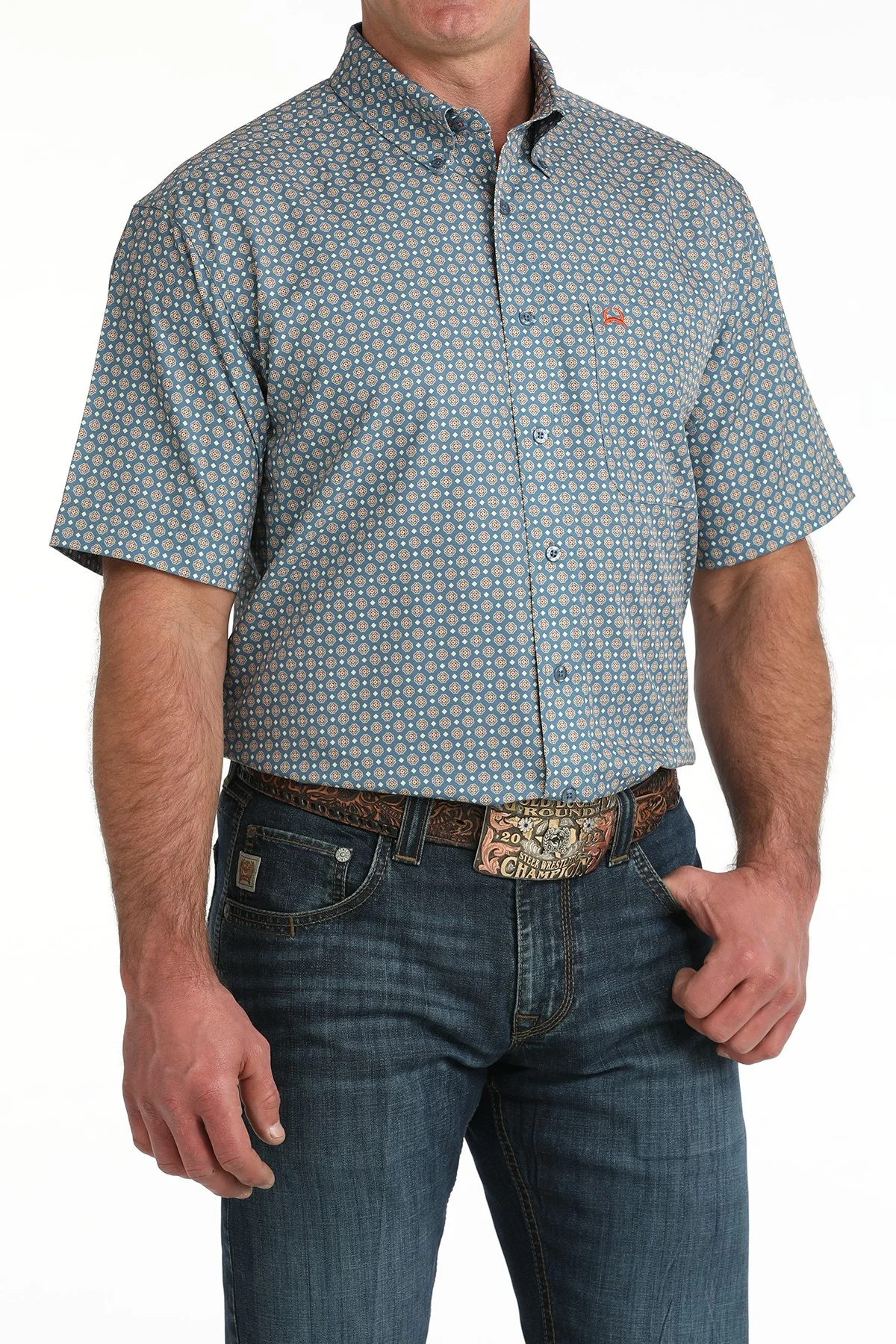 Man wearing a patterned short-sleeve shirt and jeans on a white background