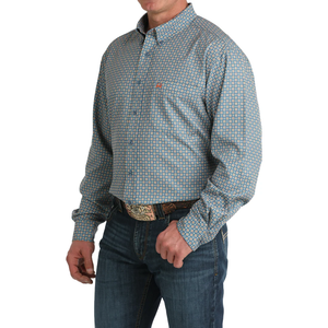 Man wearing a patterned shirt and jeans on a white background