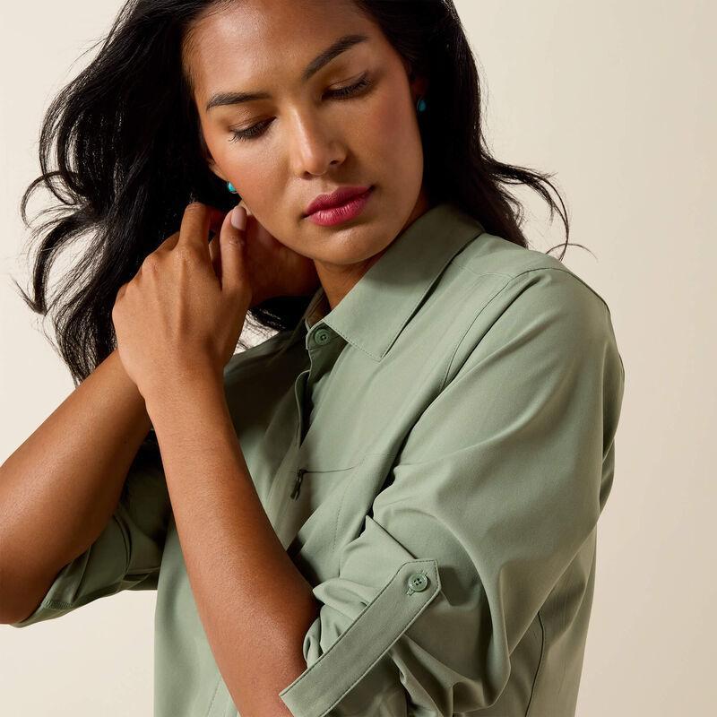 Woman wearing a light green shirt against a beige background