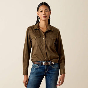 A woman modeling aolive green long-sleeve button-up shirt with two chest pockets.