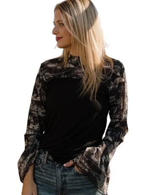 Woman wearing a black western patterned shirt