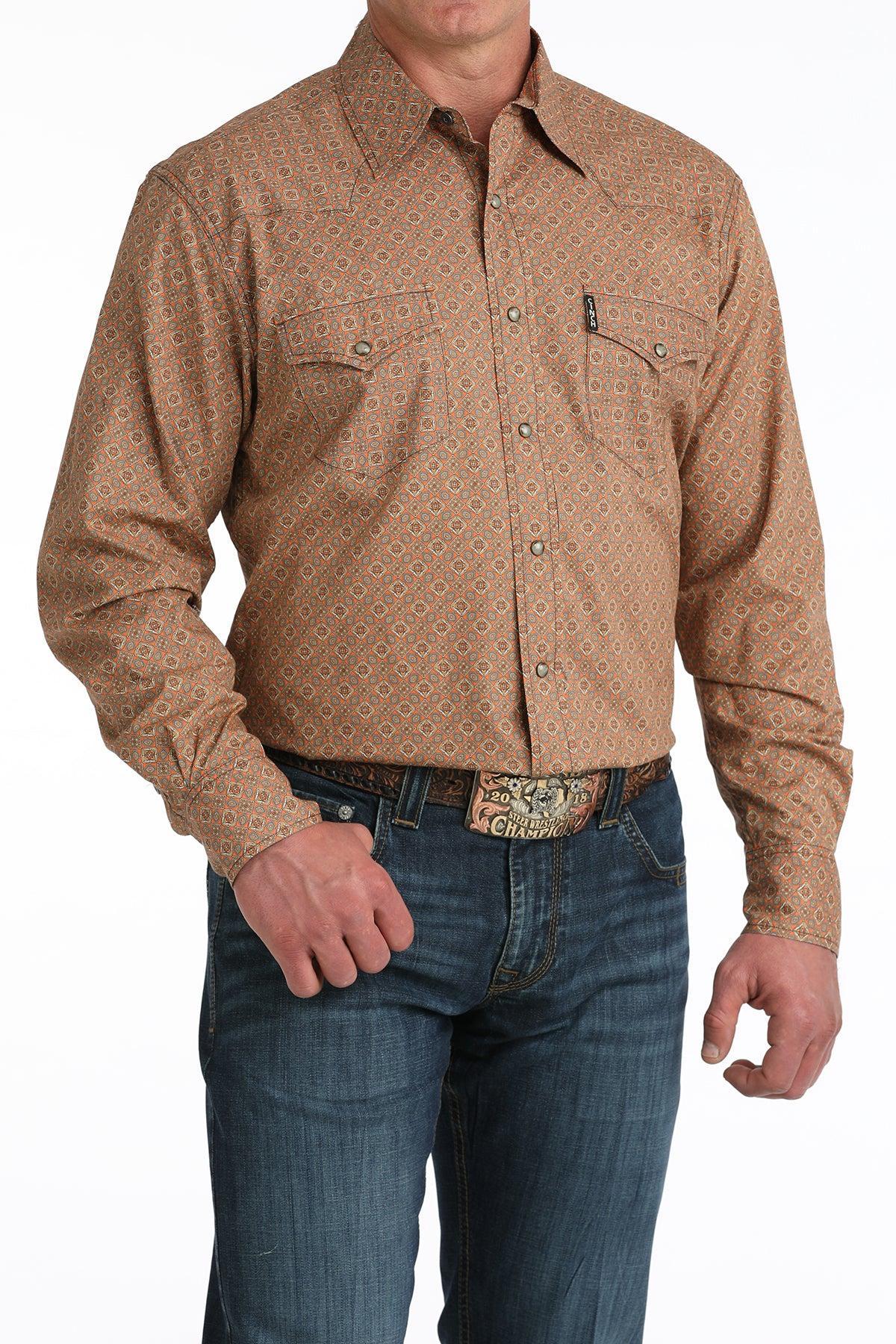 Man wearing a brown patterned shirt and blue jeans on a white background