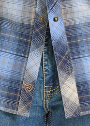 Close-up of a blue plaid shirt with a focus on the collar and buttons.