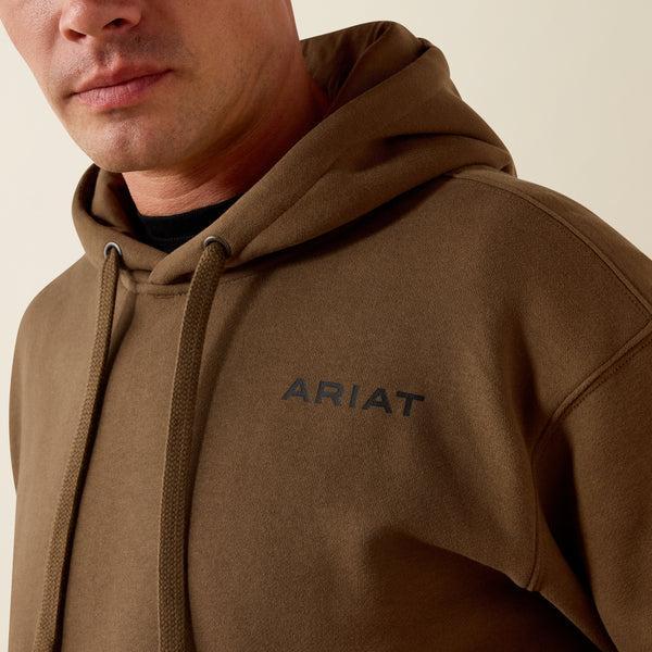 A close-up of a man wearing a brown pullover hoodie with the brand name 'ARIAT' printed in black on the left chest, set against a plain light beige background.