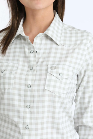 Close-up of a person wearing a light gray and white checkered shirt.