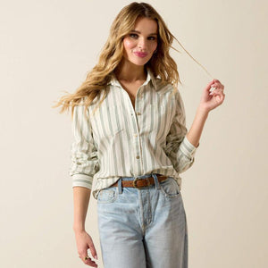 Woman wearing a striped shirt and jeans against a beige background
