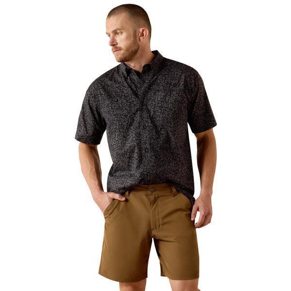 Man wearing a black patterned short-sleeve shirt
