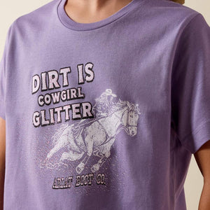 Purple t-shirt with graphic of a horse and text 'Dirt is Cowgirl Glitter' on a plain background