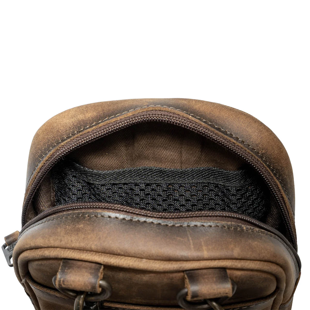 Brown leather bag with a black interior pocket on a white background