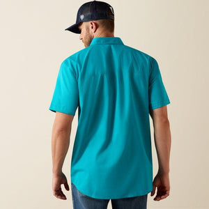 Man wearing a turquoise shirt
