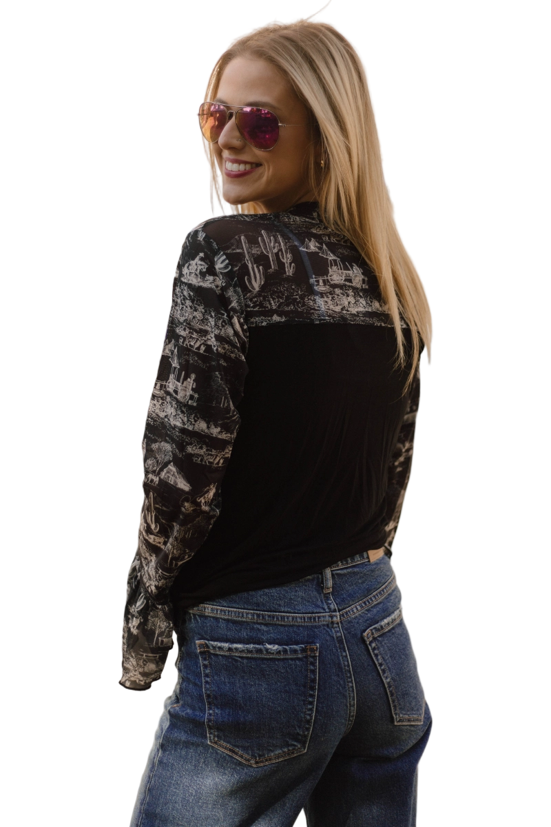 Woman wearing a black western patterned shirt