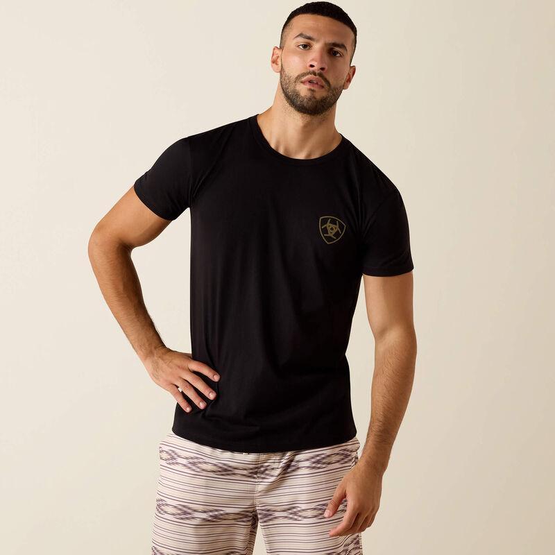 Man wearing a black t-shirt with 'Ariat Int.' logo on the back