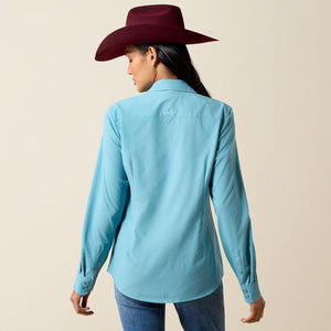 A woman modeling a light blue long-sleeve western button-up shirt