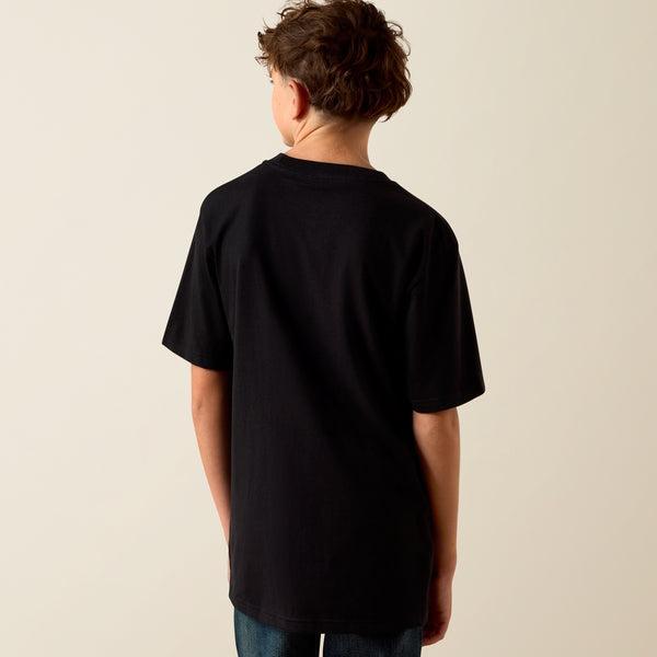 Person wearing a black t-shirt against a beige background