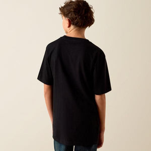 Person wearing a black t-shirt against a beige background