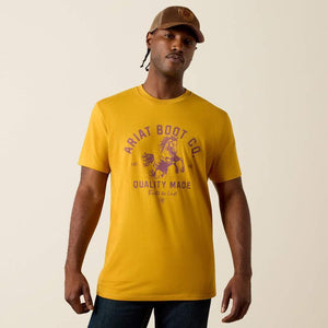 Yellow t-shirt with purple 'Ariat Boot Co.' logo and text on a yellow background