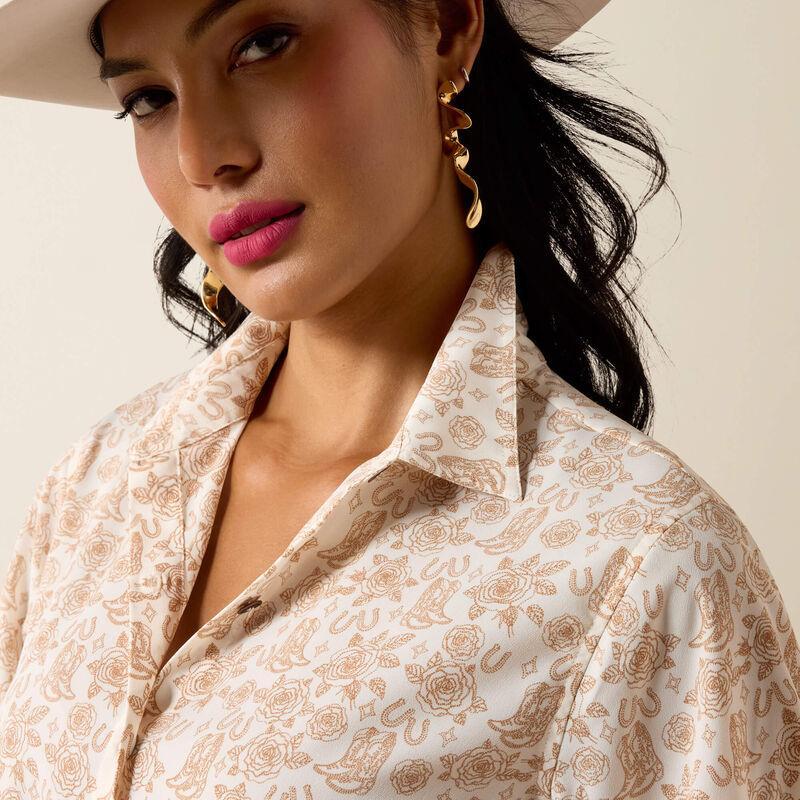 Woman wearing a patterned shirt with a neutral background